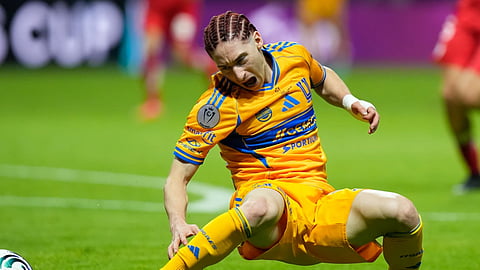 Tigres' Marcelo Flores gets injured trying to reach the ball during the CONCACAF Champions Cup final soccer match against Toluca in Toluca, Mexico