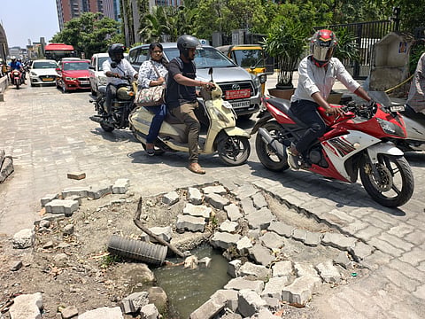 Motorists try to avoid open drains on OMR service road near World Trade Centre