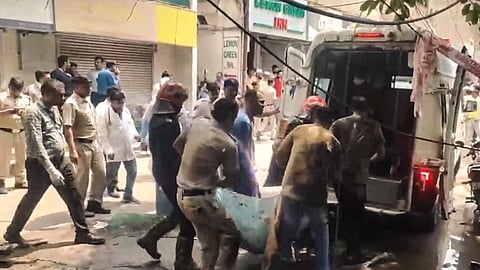 Security and health officials at the site after a fire broke out in a restaurant in south Delhi's Malviya Nagar, Wednesday, June 3, 2026