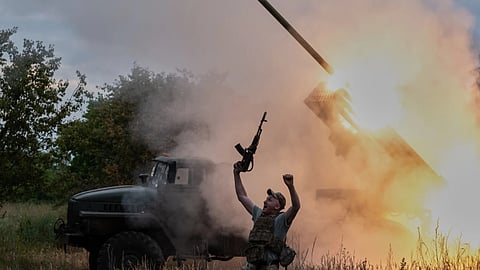 A soldier reacts as an MRLS BM-21 "Grad" fires at the Russian positions near Kostiantynivka, Donetsk region, Ukraine