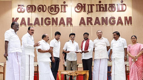 DMK president MK Stalin with the AIADMK leader who joined the party at Anna Arivalayam on Saturday