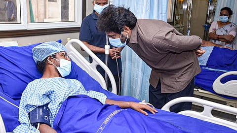 Andhra Pradesh Deputy Chief Minister Pawan Kalyan meets a person injured in the Rashtriya Ispat Nigam Ltd (Vizag Steel Plant) accident