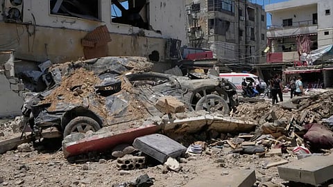 A car lies amidst debris following an Israeli airstrike in the southern port city of Tyre