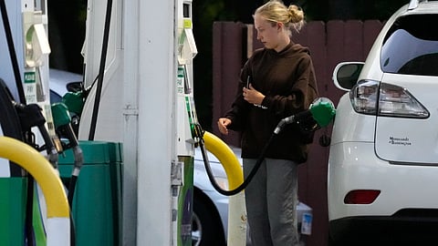 Customer checks gas price before filling her vehicle's tank in gas station