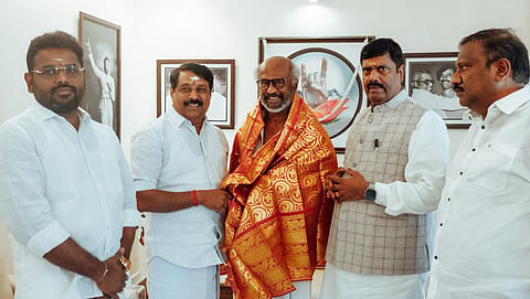 State BJP president Nainar Nagenthran presents a shawl to actor Rajinikanth during a meeting at his residence in Poes Garden in Chennai on Tuesday