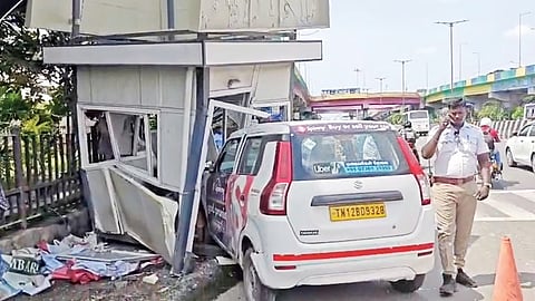 The damaged traffic booth and car near Hindu Mission Hospital