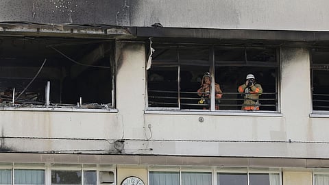 Firefighters work at the site of a fire at an elementary school in Tokyo