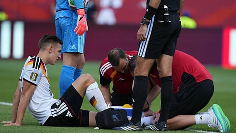 Germany's Nico Schlotterbeck receives treatment