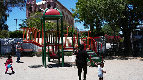 Vivianne Petit Frere walks with her granddaughter Alexca at a playground
