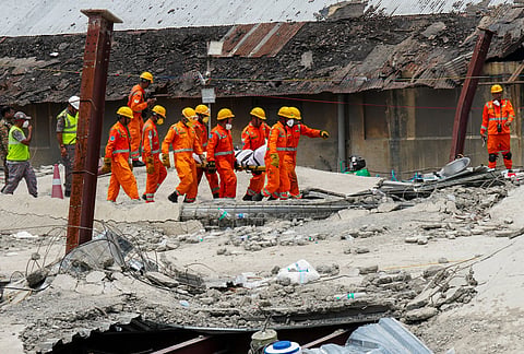 NDRF and Army officials carry the mortal remains of a victim during a rescue operation after an under-construction warehouse collapsed on Wednesday, leaving at least 11 people dead and several others injured, in Kolkata's Taratala area, Thursday, June 25, 2026
