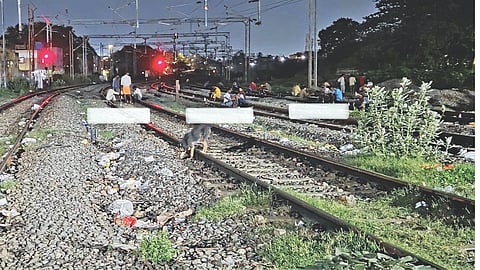 Tipplers gather to drink on the railway tracks near Level Crossing 11 A between Washermenpet and Korukkupet