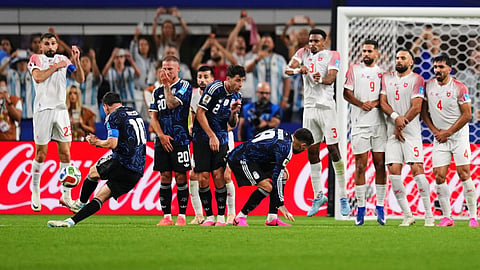 Argentina's Lionel Messi, second from left, scores his side's third goal on a free kick during the World Cup Group J soccer match against Jordan in Arlington, Texas, near Dallas