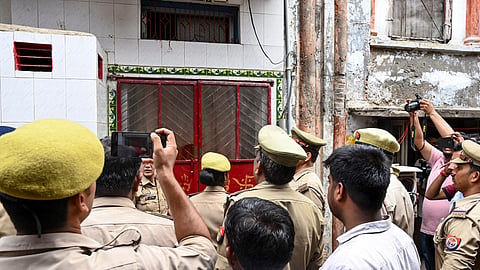 Police officials conduct a search operation at the residence of an accused in connection with an alleged embezzlement of donations at the Ram temple, in Ayodhya, Uttar Pradesh, Sunday, June 28, 2026