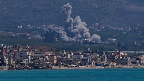 Smoke rises from an Israeli airstrike that hit Qlaileh village, as it seen from the southern port city of Tyre, Lebanon