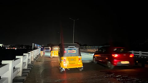 Vehicles plying on the dark stretch of the Manavalanagar road over bridge
