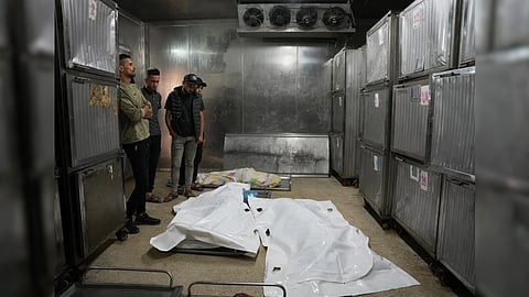 Mourners take the last look at the bodies of two Palestinian girls Zeina Safadi, and her sister Lana
