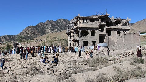 Residents walk through the rubble after what Taliban officials said were Pakistani airstrikes a day earlier that killed civilians, including children, in the village of Mandokhail, Chamkani district, Paktia province, Afghanistan