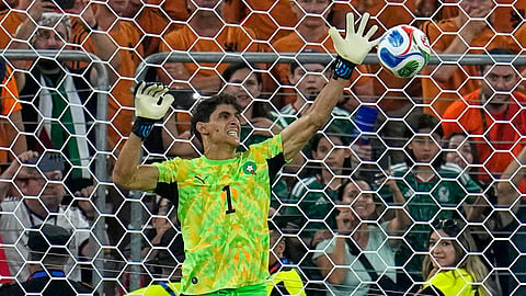 Morocco goalkeeper Yassine Bounou (1) saves a penalty from Netherlands' Crysencio Summerville (24) during the World Cup round of 32 soccer match between the Netherlands and Morocco in Guadalupe, near Monterrey, Mexico.