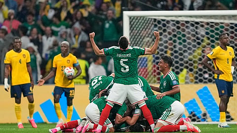 Mexico's Johan Vasquez (5) celibrates with teammates after their second goal during the World Cup round of 32 soccer match between Mexico and Ecuador in Mexico City