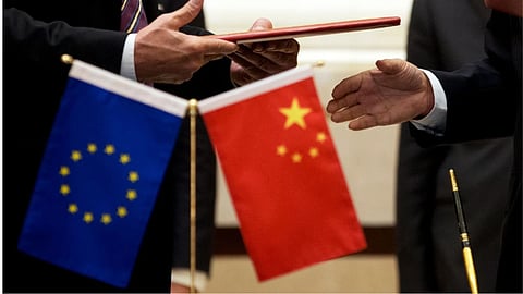 A member of European Commission, left, prepares to exchange documents with Chinese delegation at a signing ceremony after the 5th China-EU High Level Economic and Trade dialogue at Diaoyutai State Guest House in Beijing