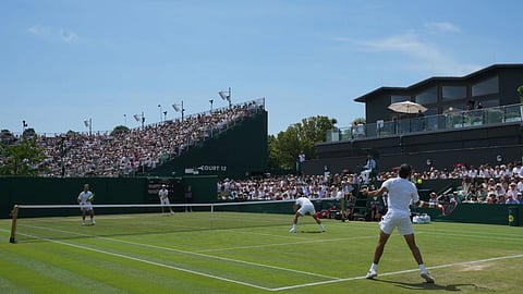 Kevin Krawietz and Tim Puetz of Germany, top, face Roman Andres Burruchaga and Thiago Agustin Tirante of Argentina in their second round men's doubles match, at the Wimbledon Tennis Championships in London