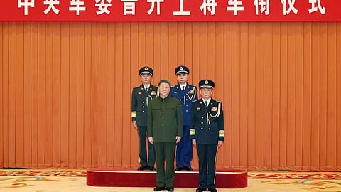 In this photo released by Xinhua News Agency, Chinese President Xi Jinping, bottom left, who is also Chairman of the Central Military Commission (CMC) poses for photos with newly promoted generals Wang Shuguang, top left and Wang Gang, top right while Zhang Shengmin, Vice Chairman of the CMC stands at the right in Beijing.