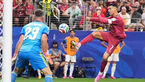 Portugal's Cristiano Ronaldo (7) shoots against Spain goalkeeper Unai Simon (23) during the World Cup round of 16 soccer match in Arlington, Texas
