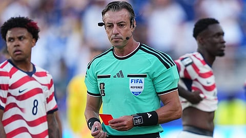 United States' Folarin Balogun, right, stands by after being issued a red card by Referee Raphael Claus, of Brazil, centre, as United States' Weston McKennie (8) looks on during the World Cup round of 32 soccer match between the United States and Bosnia in Santa Clara, Calif., near San Francisco.