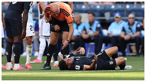 Referee Adham Makhadmeh, of Jordan, checks on United States' Christian Pulisic (10) after a challenge during the World Cup round of 16 soccer match between the United States and Belgium in Seattle, Monday, July 6, 2026.