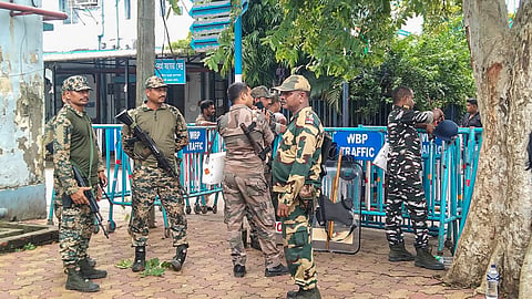 Security personnel stand guard outside Baruipur Sub-Divisional Hospital, where the body of an accused killed in a police encounter has been kept, in South 24 Parganas district