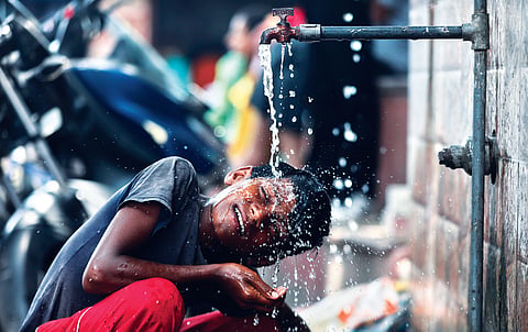 Boy drinking water from pipe
