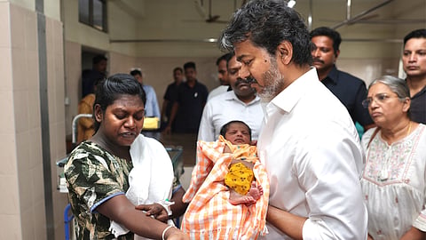 CM Vijay interacting with a new mother and her family member during the inspection at the hospital