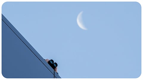 A law enforcement officer uses binoculars to watch from the roof of the Fourth District Courthouse in Provo, Utah, Thursday, July 9, 2026, before a preliminary hearing for Tyler Robinson, who is accused in the fatal shooting of Charlie Kirk.