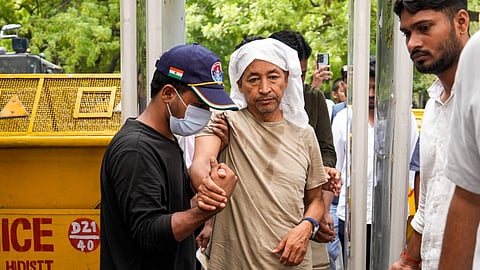 Climate activist Sonam Wangchuk being attended as Cockroach Janata Party (CJP) founder Abhijeet Dipke looks on during a protest by CJP demanding Union Education Minister Dharmendra Pradhan's resignation over alleged irregularities in the NEET examination, at Jantar Mantar, in New Delhi, Wednesday, July 15, 2026. Wangchuk has been on an indefinite hunger strike for 18 days