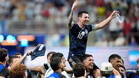 Argentina’s Lionel Messi celebrates with his teammates at the end of the World Cup semifinal soccer match between England and Argentina in Atlanta.