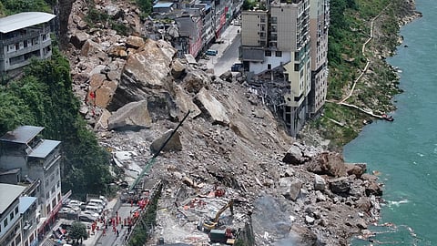 Rescuers conduct search and rescue operation on the site of the landslide in Pengshui County in southwestern China’s Chongqing.