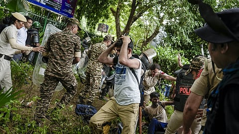 Security personnel stop Cockroach Janata Party (CJP) supporters as they raise slogans during a protest march, at Sansad Marg, in New Delhi. Delhi Police is on high alert during the Monsoon Session of Parliament and CJP's proposed "Chalo Sansad" march on July 20.