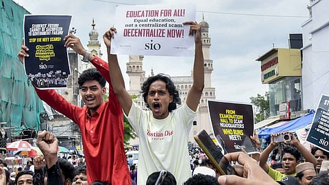 Students Islamic Organisation (SIO) Telangana members stage a protest demanding the resignation of Union Education Minister Dharmendra Pradhan over the NEET paper leak issue, at Charminar, in Hyderabad, Friday, July 24, 2026