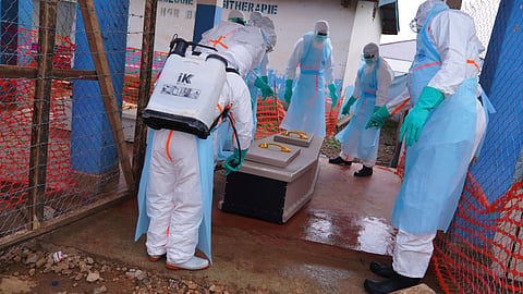 Health workers disinfect a coffin of an Ebola victim at Ebola Treatment Center at Bunia General Hospital in Ituri, Congo.