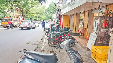A popular hair salon on Viswanathapuram Main Road, Kodambakkam, using the pavement for parking two-wheelers