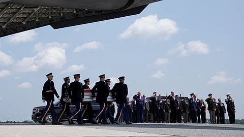 President Donald Trump and Secretary of Defense Pete Hegseth and others, salute as a U.S. Army carry team moves a transfer case containing the remains of Sgt. Angel S. Rampersad, of Ozone Park, N.Y. at Dover Air Force Base, Del.