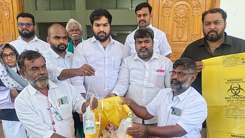 Doctors show a container filled with medical waste at Madurai Collectorate on Monday