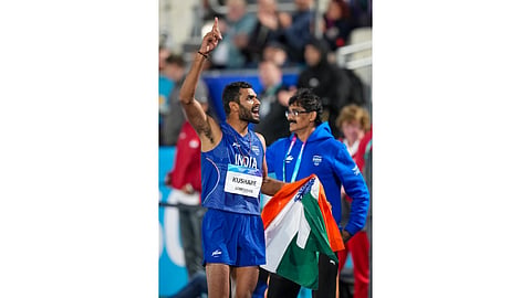Athlete Sarvesh Anil Kushare celebrates after winning the silver medal in the men's high jump final at the 23rd Commonwealth Games, in Glasgow, Scotland, Monday