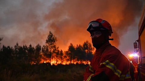 Firefighters battle a blaze outside Lanton, during wildfires in southwestern France