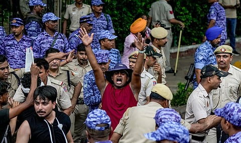 Cockroach Janata Party (CJP) supporters raise slogans during a protest march, at Sansad Marg