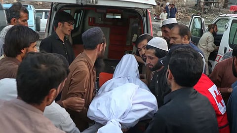 People place the body of a miner recovered after an explosion inside a coal mine, into an ambulance on the outskirts of Quetta, in southwest Pakistan, Thursday, July 30
