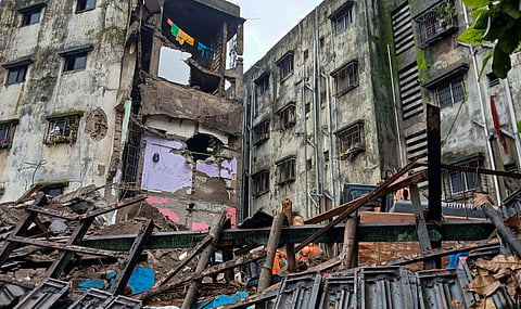 Damaged remains at the site after a portion of the Kohinoor Building in Balaji Nagar area of the powerloom town collapsed