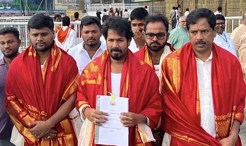 Minister Vinoth taking a copy of the State's Agriculture Budget to the Tirumala temple in Tirupati