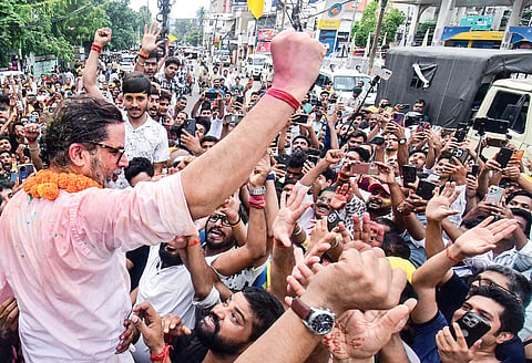 Jan Suraaj Party chief Prashant Kishor celebrates with supporters after taking lead in Bankipur seat bypoll