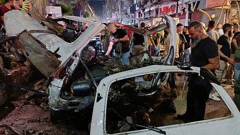 Syrian security personnel inspect damaged vehicles at the site of an explosion in the Jaramana suburb, home to a large Druze population, in Damascus, Syria